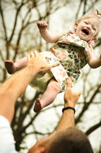 Father throwing daughter in the air