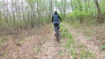 First person view. Two cyclists riding on his bikes on forest. Bike rider on the trail in the autumn forest.