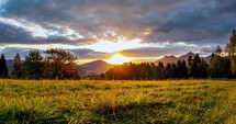 Colorful sunrise over alpine meadow nature in summer morning time lapse
