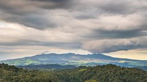 Dramatic storm clouds over Pirongia mountains forest park in New Zealand nature landscape Time lapse