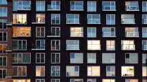 day to night time-lapse of a modern apartment building