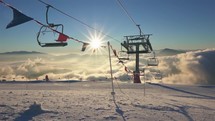 Sunny winter morning in mountains ski resort with empty chairlift at open new season

