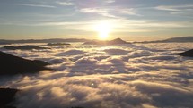 Aerial hyperlapse Peaceful sunrise wave of foggy clouds motion fast in sunny morning nature in alpine mountains heaven
