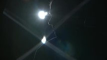 a man standing under spotlights 