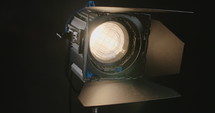 Film light switching on and creating a lens flare.
