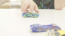child playing with toy cars