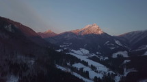 Aerial view of winter sunset over alpine mountains
