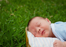 Infant sleeping in park