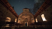 Starry night over historic church ruin Time-lapse
