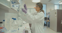 Female lab technician working in a pharmaceutical laboratory conducting experiments
