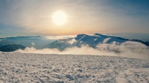 Panorama of frozen winter mountains with foggy clouds in valley in magic morning sunrise nature
