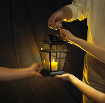 hands on a candle lantern 