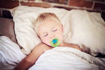 sleeping toddler with pacifier 