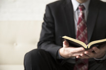 businessman reading a Bible 