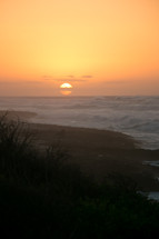 waves along a shore at sunset 
