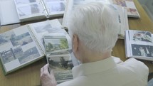senior man looking through a photo album 
