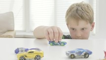 boy playing with toy cars 