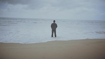a man looking out at the ocean 
