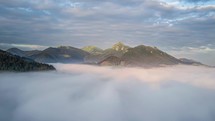 Aerial view above clouds in morning mountains Time lapse
