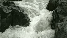 water flowing between rocks in a river 