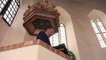 Man reading in pulpit