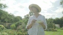 Senior caucasian woman drinking tea in her garden themes of retirement seniors relaxing drinking
