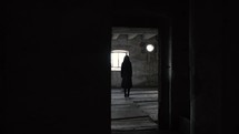 Girl standing in an empty old room