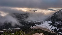 Epic misty mountains with low clouds motion fast in winter morning nature landscape at sunrise time-lapse
