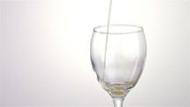 Slow motion beer tapping, Draft beer into a wine glass isolated on white background
