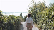 Back Shot of Woman walking near the Beach