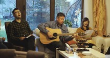 People singing in worship in a living room