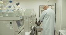 Scientist working with mass spectrometer in a pharmaceutical laboratory conducting experiments