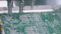 Surface mount technology machine places resistors, capacitors, transistors, LED and integrated circuits.
