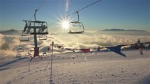 Empty chairlift in ski resort in beautiful sunny morning nature in winter skiing season slow motion
