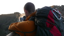 a man with a video camera filming a mountain 