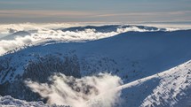 Sunny winter in Carpathian mountains with misty clouds motion fast in cold frozen nature Time-lapse
