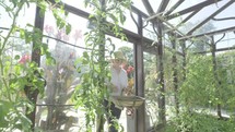 Senior caucasian woman gardening in her greenhouse themes of retirement seniors gardening hobbies
