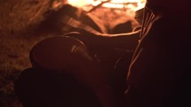 Detail of mans hands play drums in peaceful summer evening by a fire, fast drumming Djembe percussion music
