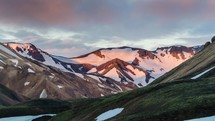 Sunset colors of mountains and clouds in Iceland Landmannalaugar. Time lapse zoom in
