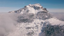 Majestic alpine Peak in beautiful sunny day in misty mountains nature Aerial view Adventure background
