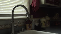 water dripping from a kitchen faucet 