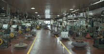 Large factory for metal parts and bolts manufacturing with machines and workers