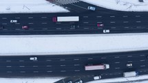 Winter traffic on snow highway aerial view.