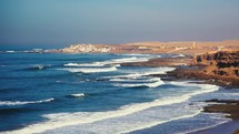 Peaceful waves of blue ocean in Morocco coastline beach
