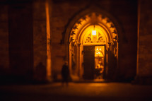 church light in a church doorway at night 