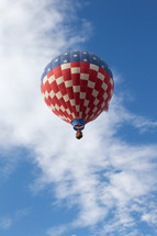 Red, white and blue balloon flying in the blue sky.
