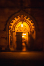 glowing light in a church doorway at night 