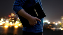 man carrying a Bible at his side 