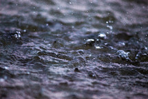 rain drops falling on dry soil 