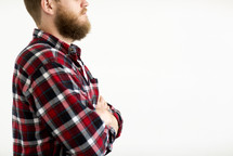 a man in a plaid flannel shirt in studio 
